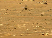NASA photo of the helicopter Ingenuity flying up from Mars' surface and landing. A still from a video.