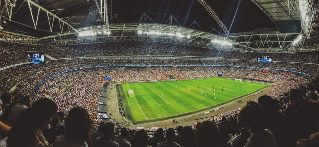 a large soccer field surrounded by fans in the stands