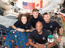 The Artemis II crew – (clockwise from left) Mission Specialist Christina Koch, Mission Specialist Jeremy Hansen, Commander Reid Wiseman, and Pilot Victor Glover as well as "Rise" the stuffie that indicates they are in zero gravity
